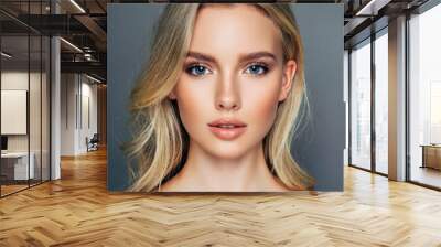 Beauty fashion portrait of young blond woman model with natural makeup and perfect skin posing Wall mural