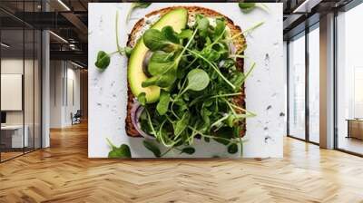 Toast with avocado and watercress salad on a white background Wall mural