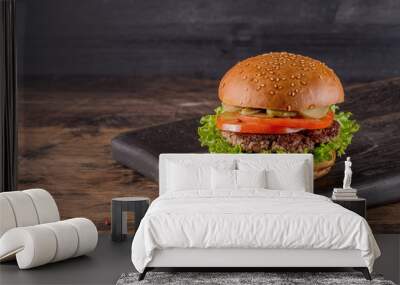 Fresh burger on a wooden background in rustic style. Wall mural