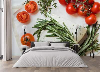 Brie or Camembert cheese with rosemary and tomatoes on white background. Top view Wall mural