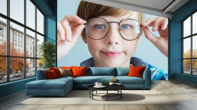 Little boy wearing glasses at ophthalmologist's office. Boy child kid wearing glasses.myopia or Short sighted. Positive human emotion Wall mural