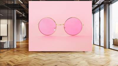 Round hipster sunglasses with pink lenses and golden frame. Fashion accessory for women Wall mural