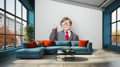 smiling child boy pointing his index finger at something on white background. success, creative and  Wall mural