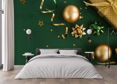 christmas or new year frame decorations in gold colors on dark green color background with empty copy space for text. holiday and celebration concept for postcard or invitation. top view  Wall mural