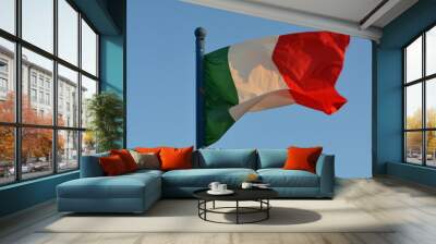 Bandera italiana: verde, blanca y roja; movida por el  viento al atardecer. Wall mural