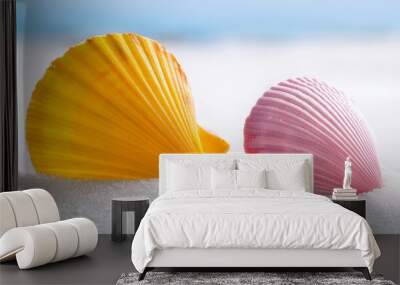 closeup photography of two yellow and pink seashells on white sand Wall mural