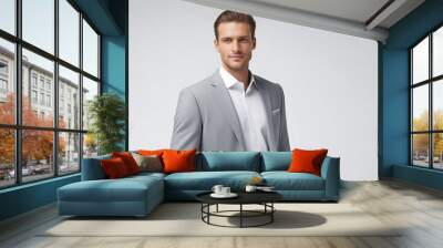 portrait of a businessman. This modern businessman exudes authority and ambition, posed in a stylish suit against a crisp white backdrop that enhances his profile. Wall mural