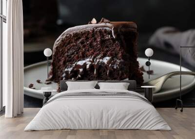 Close-up shot of a piece of chocolate sponge cake on a white plate Wall mural