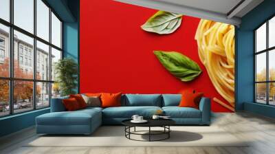 Plate of spaghetti with tomatoes and basil leaves on a red background. National Spaghetti Day. Horizontal banner. free space for text. Italian food Wall mural