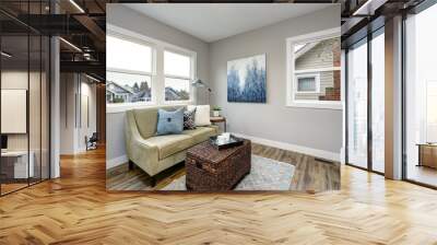 Cozy seating area with a rattan trunk coffee table and an ivory sofa. Wall mural