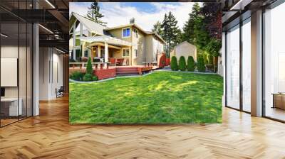 Luxury waterfront house exterior with well kept lawn. Wall mural