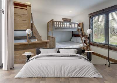 Natural tone bunk bed kids  bedroom interiors in new American vacation home. Wood furniture and beige carpet. Wall mural