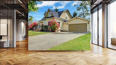 Yellow house exterior with spring blooming rhododendron Wall mural