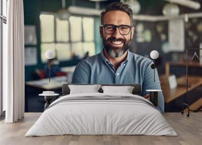 Handsome bearded man teacher in classroom with arms crossed, cheerful education from elementary to university Wall mural