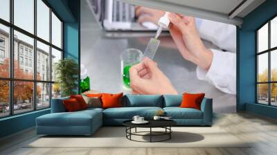 Close up of  Scientist is dropping the test of 
the result of laboratory eco or natural cosmetic, medicine, Skin care, organic make-up, beauty treatment and essential oil experiment. Wall mural