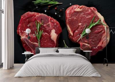  two raw steaks top view on a black background Wall mural