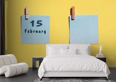 15st of February. 15st day of the month, calendar date. Two blue sheets for writing on a yellow background. Top view, copy space. Winter month, day of the year concept Wall mural