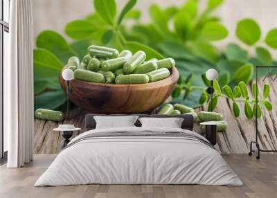 A bowl of green pills is on a wooden table Wall mural