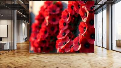 Array of red poppy wreaths displayed on a memorial wall during golden hour copy space Wall mural