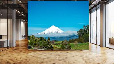 Snow covered cone of Mt Taranaki rising above the clouds. New Zealand Wall mural