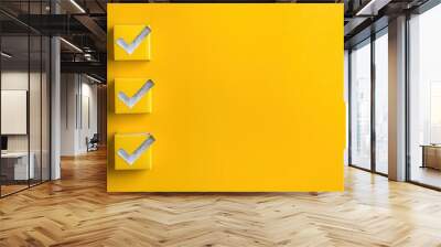 Three yellow square boxes each with a silver checkmark on a vibrant yellow background with ample negative space for design use
 Wall mural