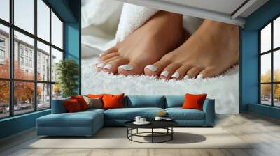 Well-groomed beautiful female feet with white pedicure for pedicure salon. White nail polish. Copy space Wall mural