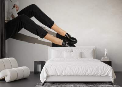 black loafers on female legs close-up Wall mural