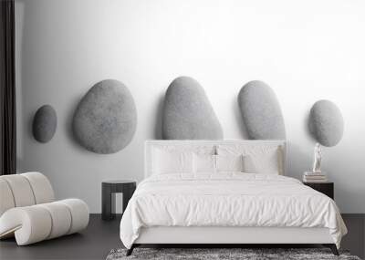 Grey pebbles on white background Wall mural