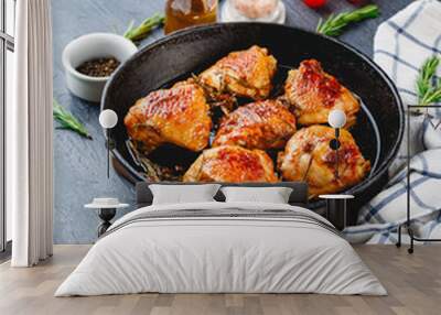 Delicious fried chicken thighs in a cast iron skillet Wall mural