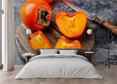 Ripe persimmon fruit on dark Wall mural