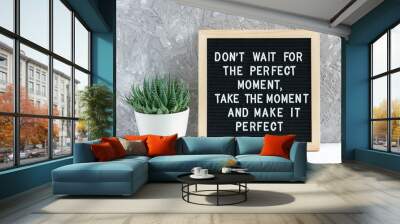 Don't wait for the perfect moment, take the moment and make it perfect. Motivational quote on letter board, succulent flower and glasses on table. Concept inspirational quote of the day Wall mural