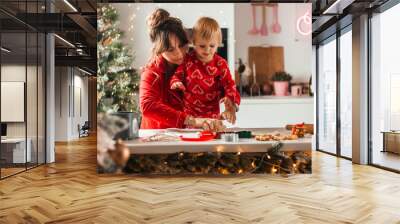 happy family mothe and daughter bake cookies for christmas in the kitchen with garlands Wall mural