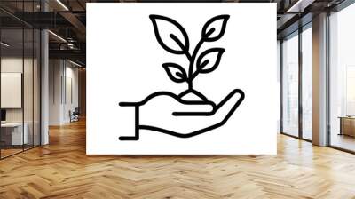 Hand holding a small plant icon on a simple background Wall mural