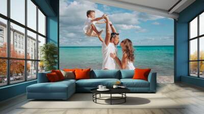 Happy family on the beach. Family vacation on the sea coast Wall mural