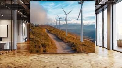 Wind turbines line a grassy hill under a clear blue sky, representing clean energy and sustainability Wall mural