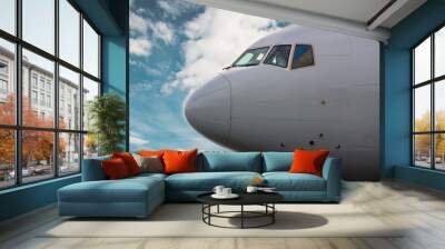 White passenger plane takes off from the airport runway. Airplane front view. Wall mural