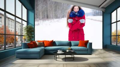 Young woman feeling cold outdoors winter time Wall mural