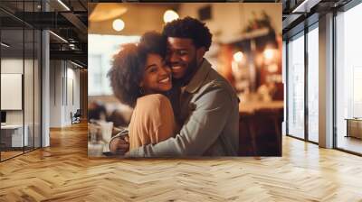 Portrait of a beautiful young black lovers hugging, smiling and loving each other. A couple of men and a woman in love celebrate Valentine's Day in a cozy cafe. The concept of romantic relationships. Wall mural