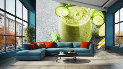 Refreshing summer cucumber green apple smoothie in a glass on concrete background. Selective focus, copy space. Wall mural