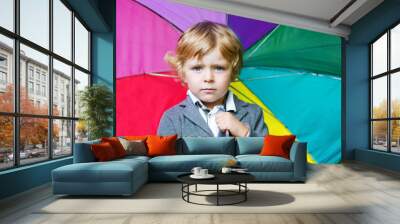 Little cute toddler boy with colorful umbrella and boots, outdoo Wall mural