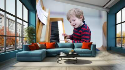 two years old toddler boy playing piano Wall mural