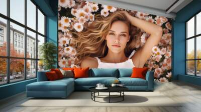 Beautiful woman lying in a garden of spring flowers Wall mural