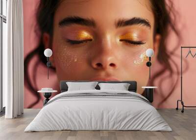 Gold smoky eyes. Shimmering makeup on the face of a young beautiful woman with perfect skin Wall mural