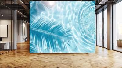 Surface of blue pool water with shadow from palm leaf, abstract summer fresh background Wall mural