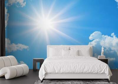 Shining sun through fluffy clouds on blue clean sky background Wall mural