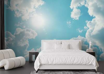 Shining sun through fluffy clouds on blue clean sky background Wall mural