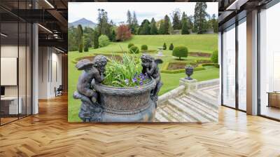 Stone vase in the old classical style with flowers in the park. Powerscourt Estate. Ireland Wall mural