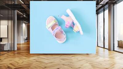 Stylish holographic sandals for kids on blue background. Shiny fashion summer shoes. Flat lay, Top view Wall mural