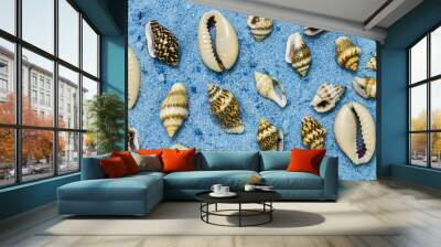 Summer background, seashells on blue sand Wall mural