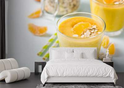 Tangerine turmeric smoothie. Selective focus, space for text. Wall mural